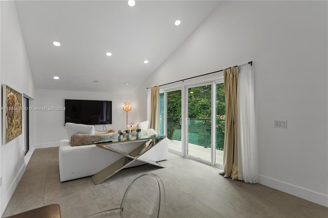 living room with high vaulted ceiling