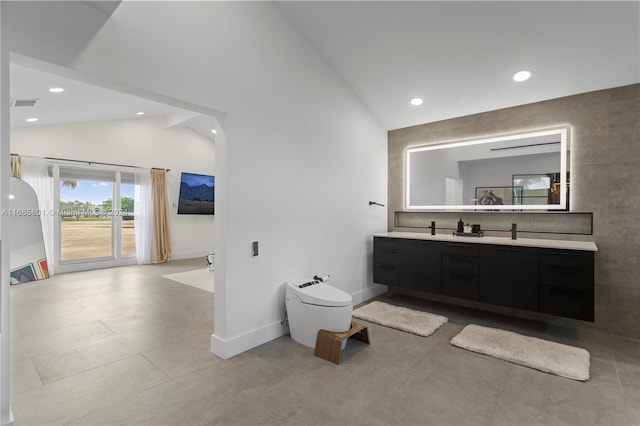 bathroom featuring vanity and vaulted ceiling