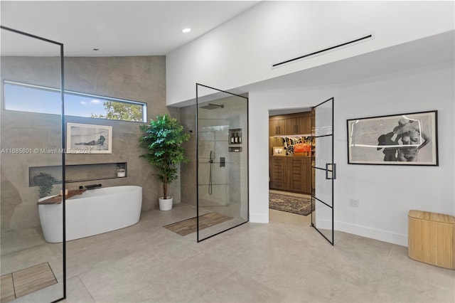 bathroom featuring vaulted ceiling and separate shower and tub