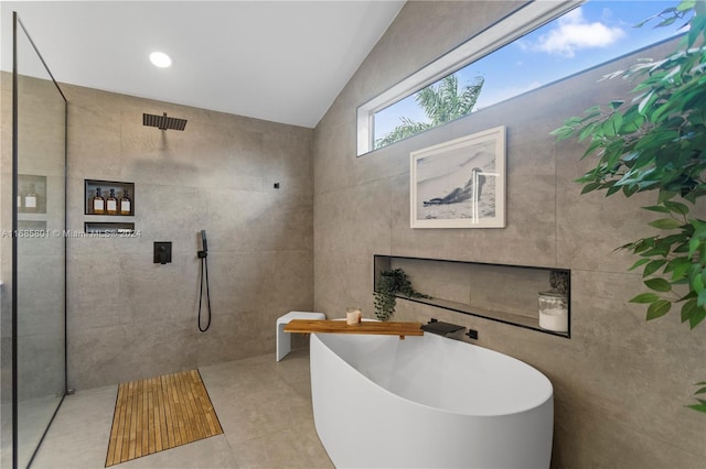 bathroom featuring tile walls, tile patterned flooring, plus walk in shower, and lofted ceiling