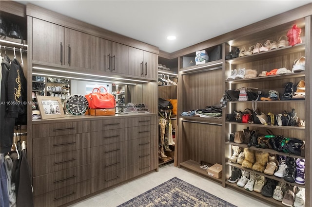 spacious closet with light tile patterned floors