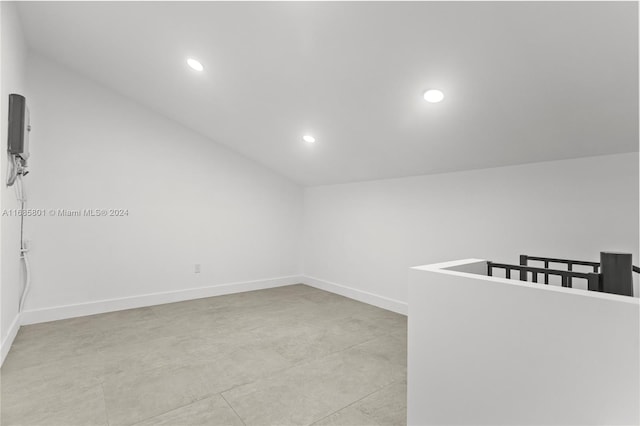 unfurnished room with vaulted ceiling