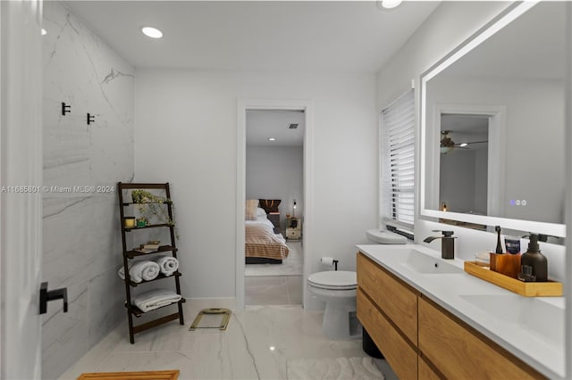 bathroom with toilet, vanity, and ceiling fan