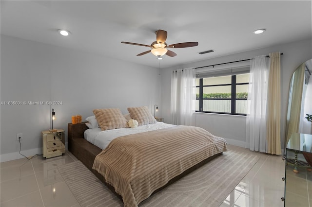 tiled bedroom featuring ceiling fan