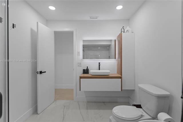 bathroom with toilet and vanity