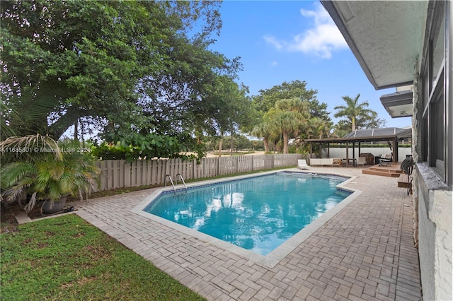 view of swimming pool featuring a patio and a gazebo