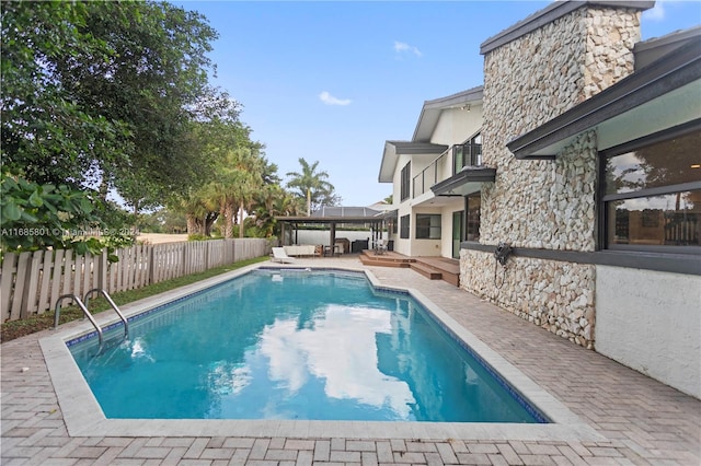 view of swimming pool featuring a patio area