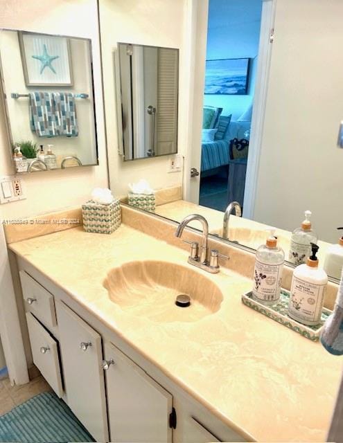 bathroom featuring tile patterned flooring and vanity