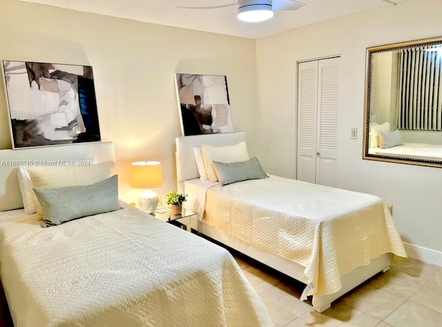 bedroom featuring tile patterned flooring, ceiling fan, and a closet