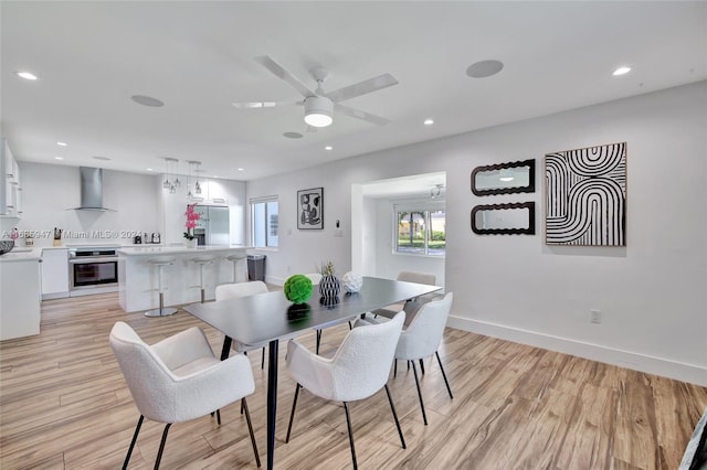 dining room featuring light hardwood / wood-style floors and ceiling fan