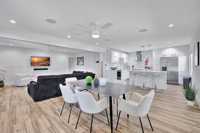 dining space featuring ceiling fan and light hardwood / wood-style flooring