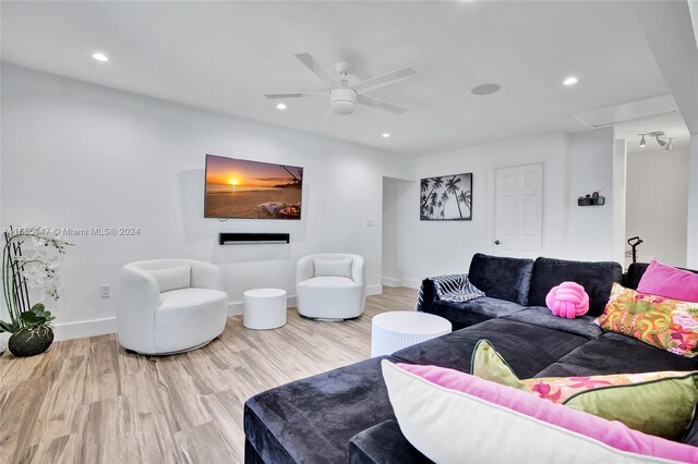 living room with hardwood / wood-style floors and ceiling fan