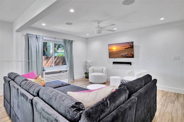 living room featuring ceiling fan and light hardwood / wood-style flooring