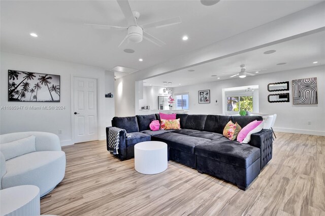 living room with light hardwood / wood-style floors and ceiling fan