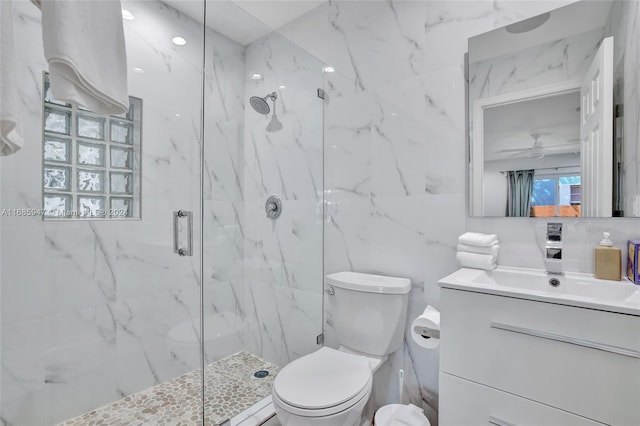 bathroom with toilet, ceiling fan, tile walls, walk in shower, and vanity