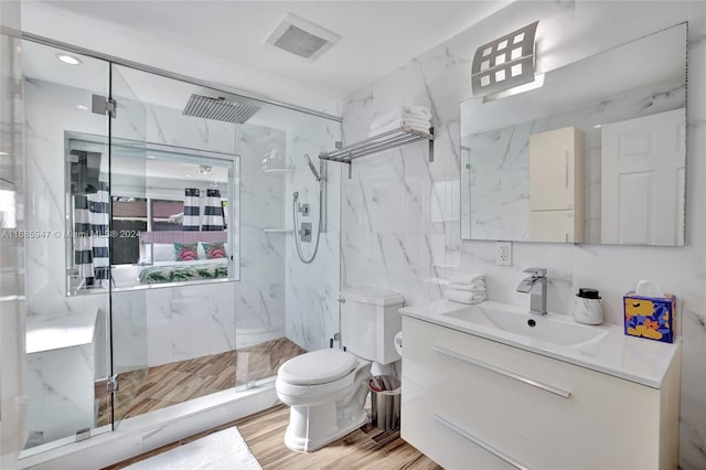 bathroom with hardwood / wood-style flooring, toilet, backsplash, vanity, and an enclosed shower