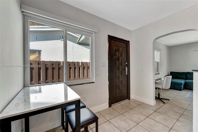 entryway with light tile patterned floors