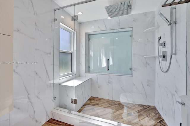 bathroom featuring walk in shower and hardwood / wood-style flooring