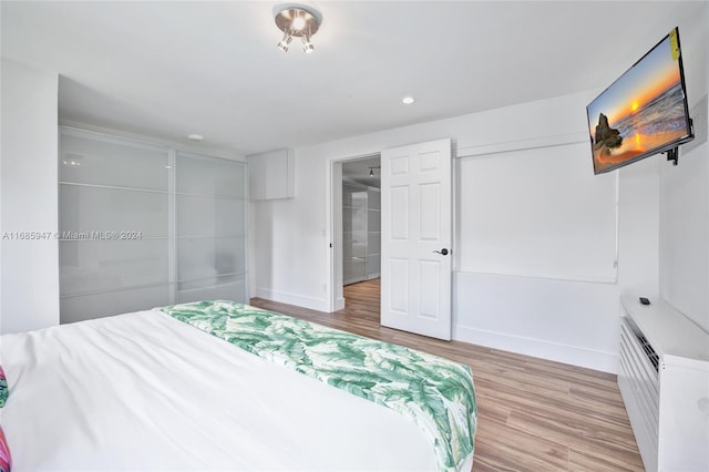 bedroom featuring a closet and light wood-type flooring