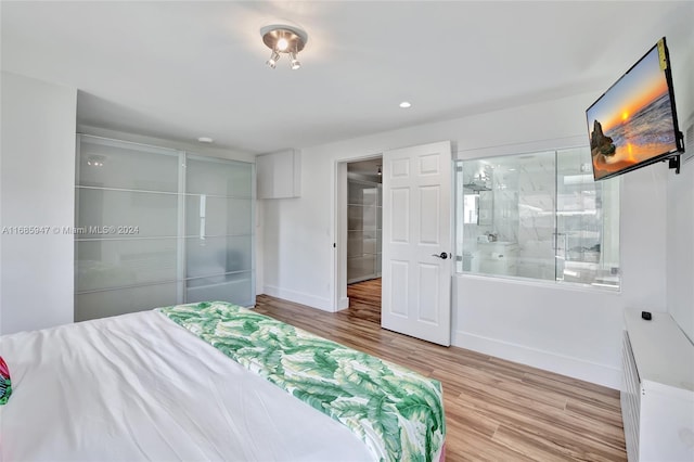 bedroom featuring light hardwood / wood-style flooring and a closet