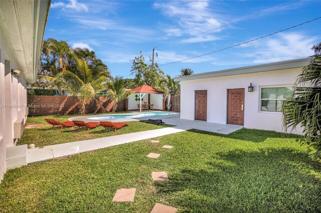 view of yard with a fenced in pool