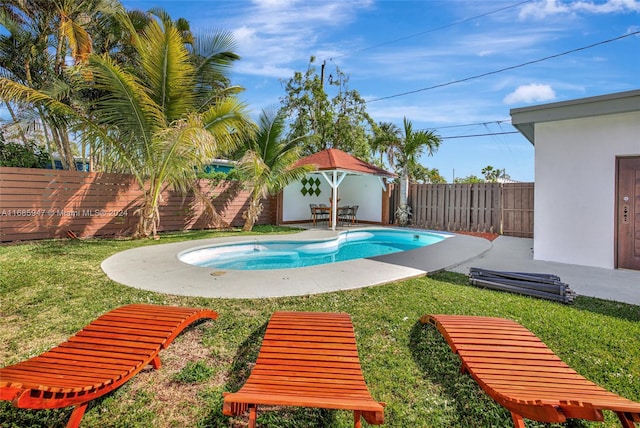 view of swimming pool featuring a patio and a yard