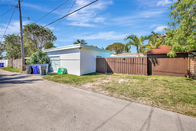 view of side of home with a yard