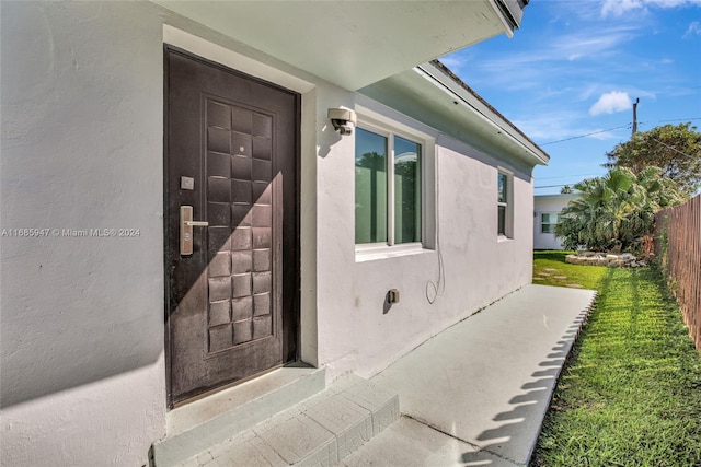 doorway to property with a yard