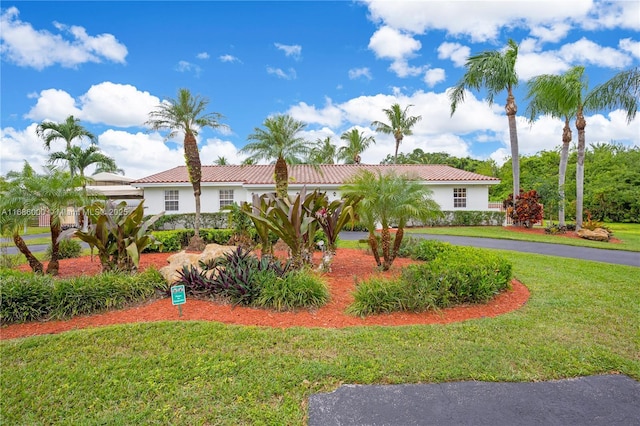 mediterranean / spanish-style home with a front lawn