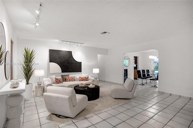 tiled living room with a textured ceiling