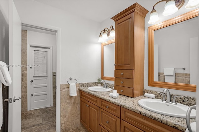 bathroom featuring vanity and tile walls