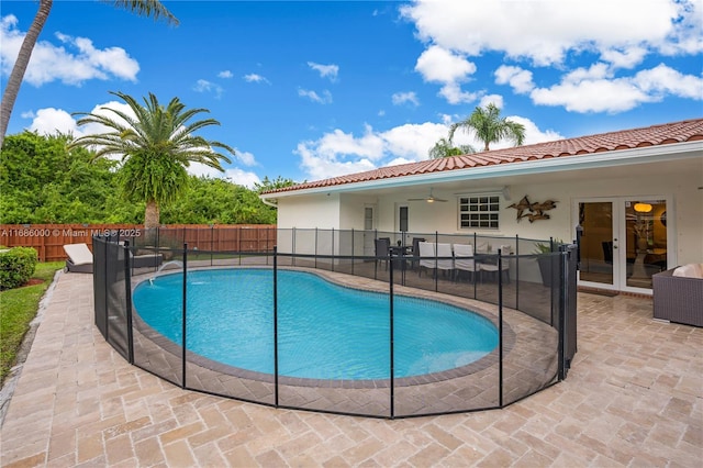 view of pool with a patio, ceiling fan, and french doors