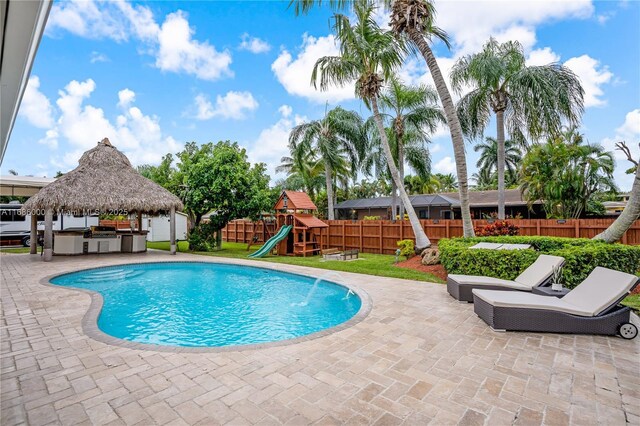 view of swimming pool featuring french doors, ceiling fan, and a patio