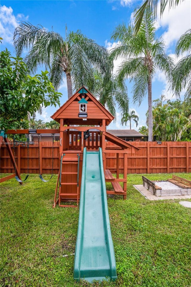 view of yard featuring a fire pit and a storage shed