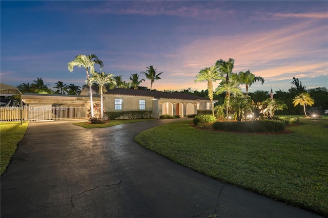 ranch-style home with a yard