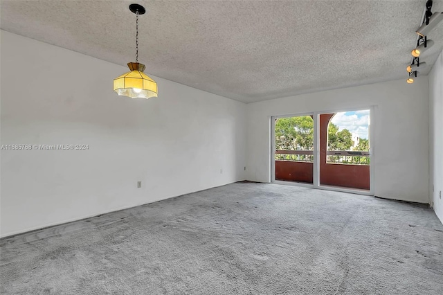 empty room with a textured ceiling and carpet