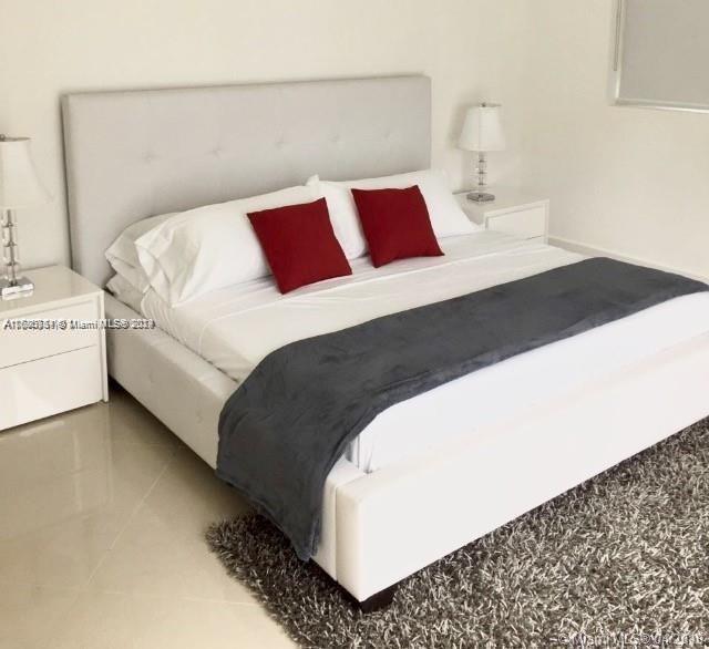 bedroom with light tile patterned floors