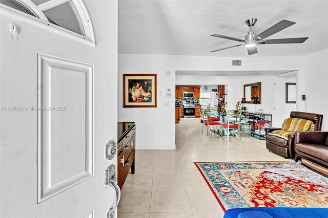 living room with light tile patterned floors and ceiling fan