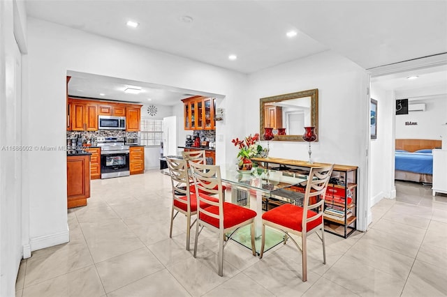 tiled dining area featuring a wall unit AC