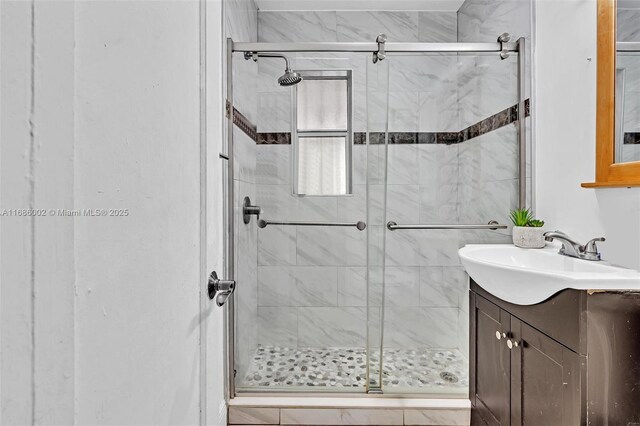 bathroom with vanity and a shower with shower door