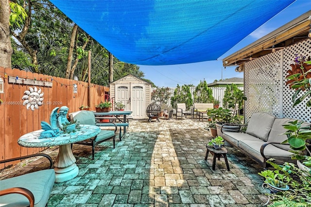 view of patio featuring outdoor lounge area and a storage shed