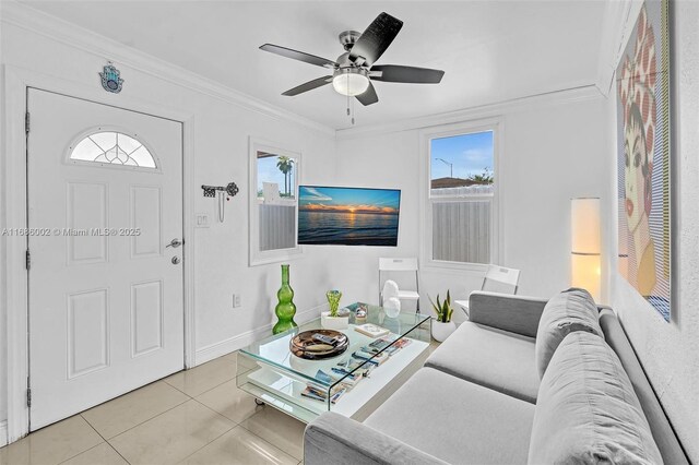 sitting room with crown molding, tile patterned floors, and ceiling fan