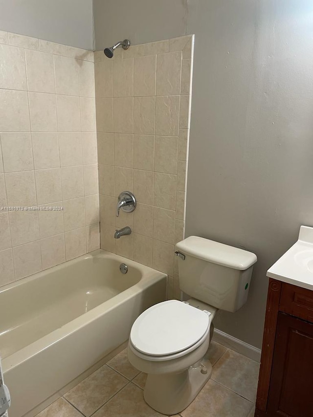 full bathroom with toilet, tiled shower / bath combo, vanity, and tile patterned flooring