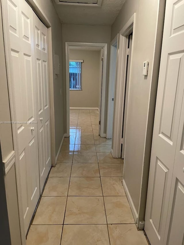 corridor with light tile patterned floors