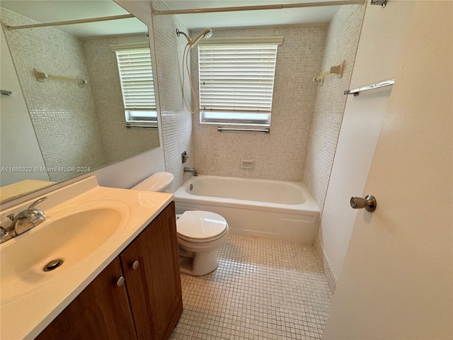 full bathroom featuring vanity, tiled shower / bath combo, toilet, and tile patterned flooring