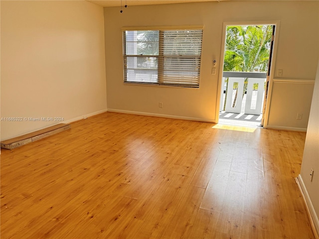 empty room with a healthy amount of sunlight and light hardwood / wood-style floors