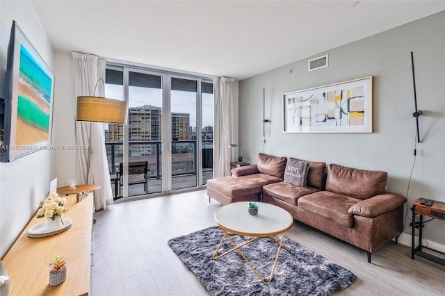 living room featuring hardwood / wood-style floors and a wall of windows