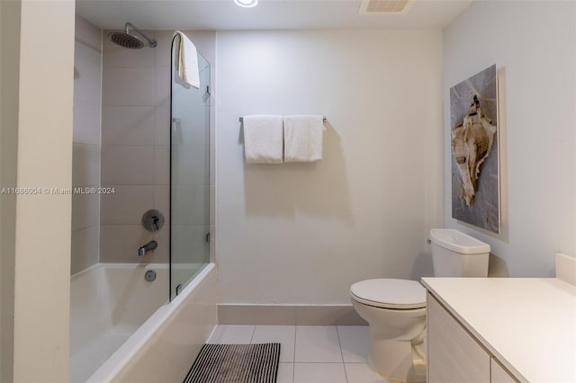 full bathroom featuring tile patterned flooring, vanity, toilet, and tiled shower / bath combo