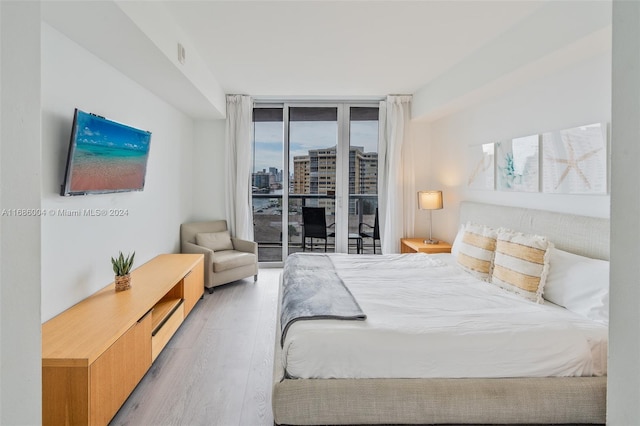 bedroom with access to outside and light hardwood / wood-style flooring