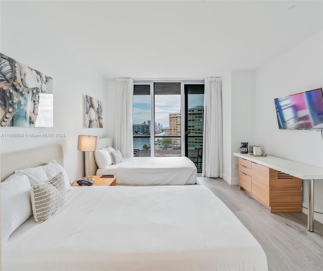 bedroom featuring access to outside and light hardwood / wood-style floors